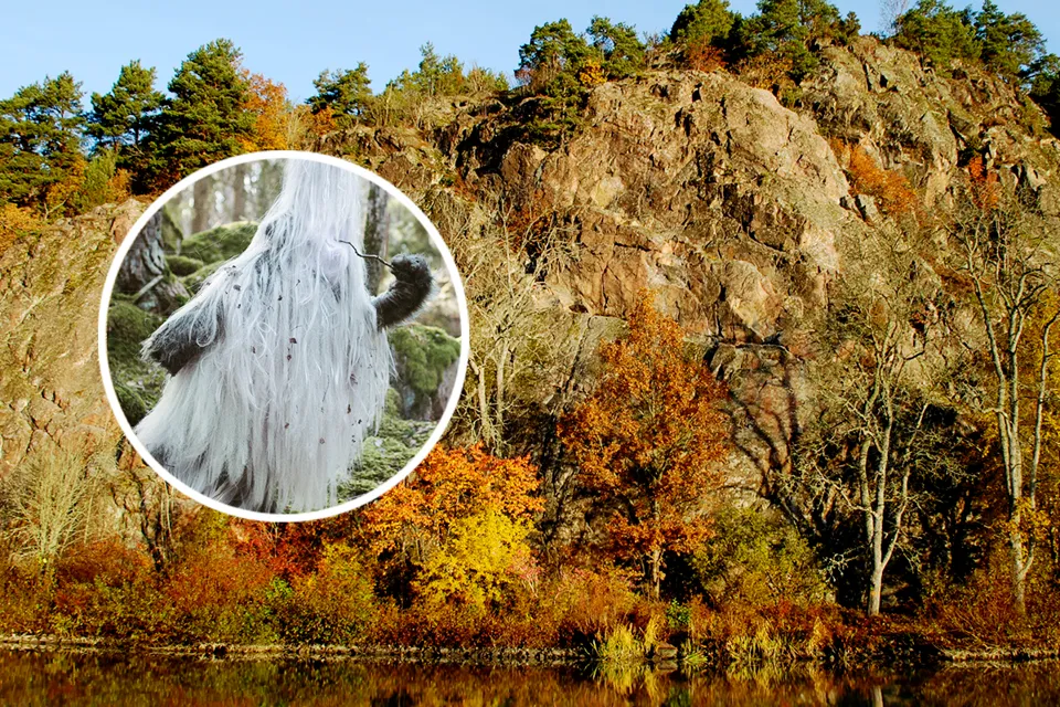 A picture of a mountain in the middle of a lake.